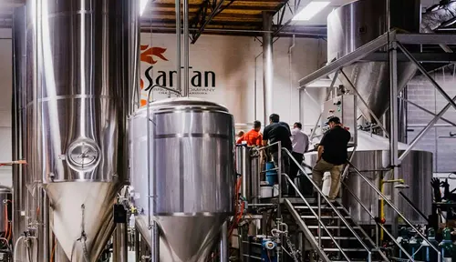 Interior of a beer brewery with large stainless steel tanks